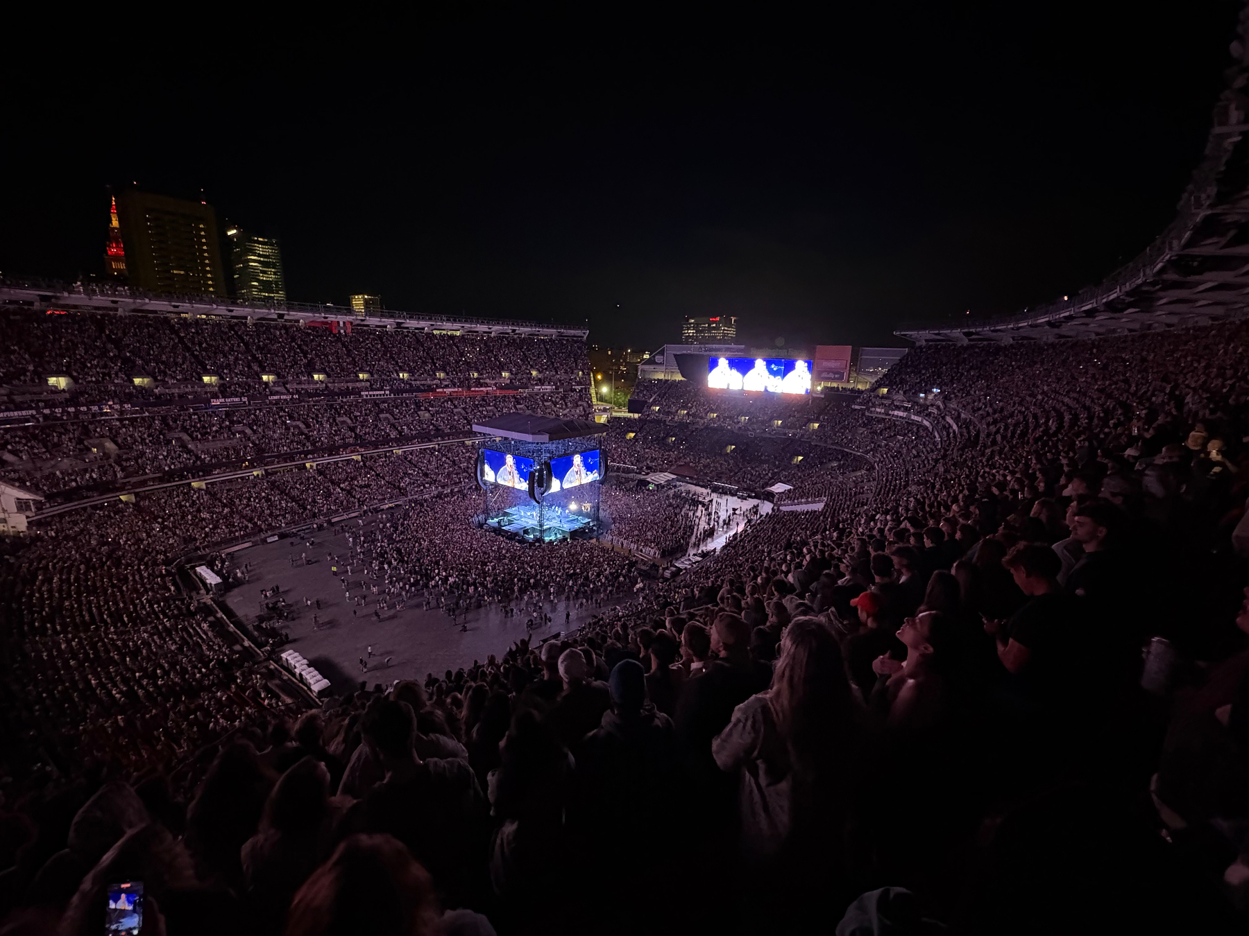 a concert stage at night from the nosebleeds